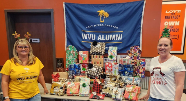 On the right, Jaclyn Hartley, President of the Fort Myers Chapter of WVU's Alumni along with her elf-in-chief, Ann Simpson!